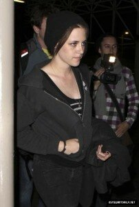 Kristen Stewart hides her hair inside a black beanie as she heads to her flight at LAX airport in Los Angeles on early Friday morning (May 28).
